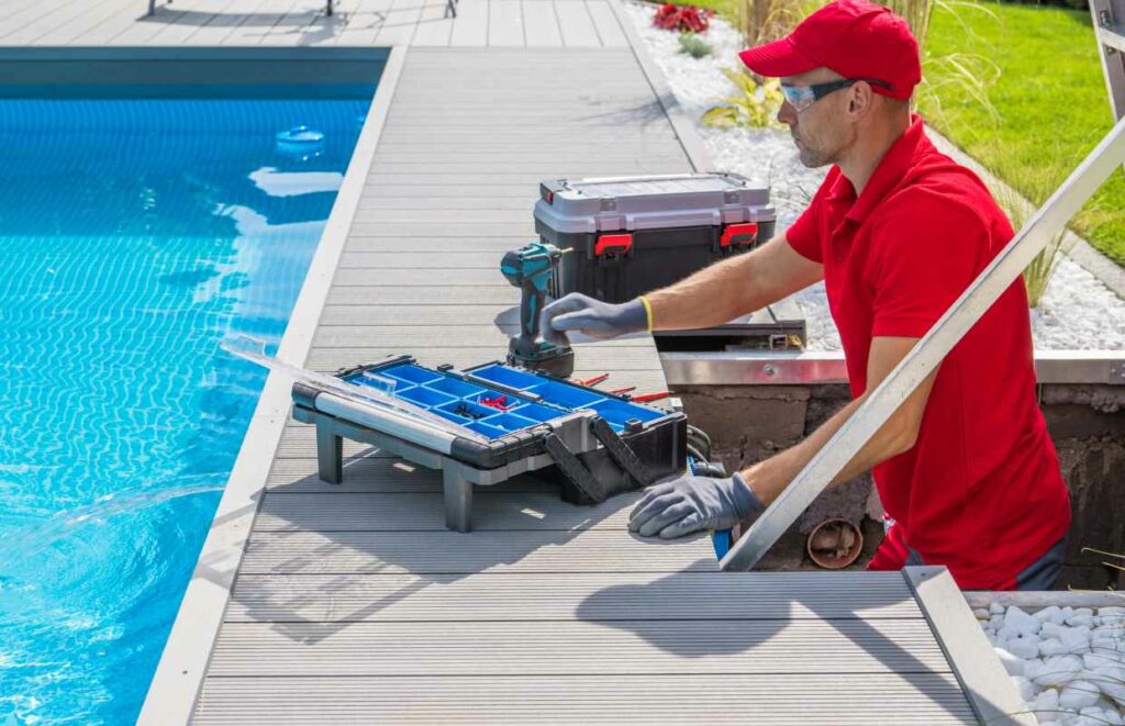 A pool technician performing maintenance on an outdoor pool 