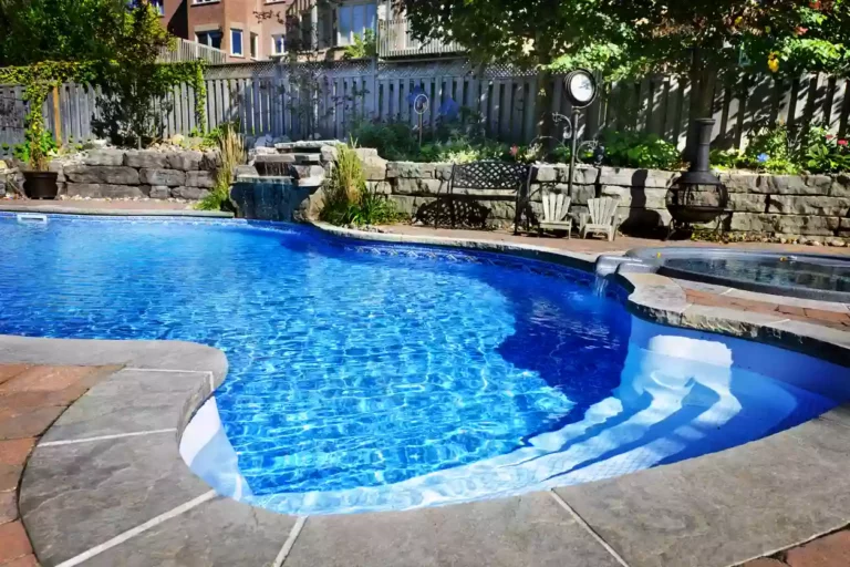 Beautiful backyard swimming pool accented with a waterfall