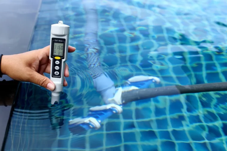 A person tests the chemicals for routine maintenance in a pool.